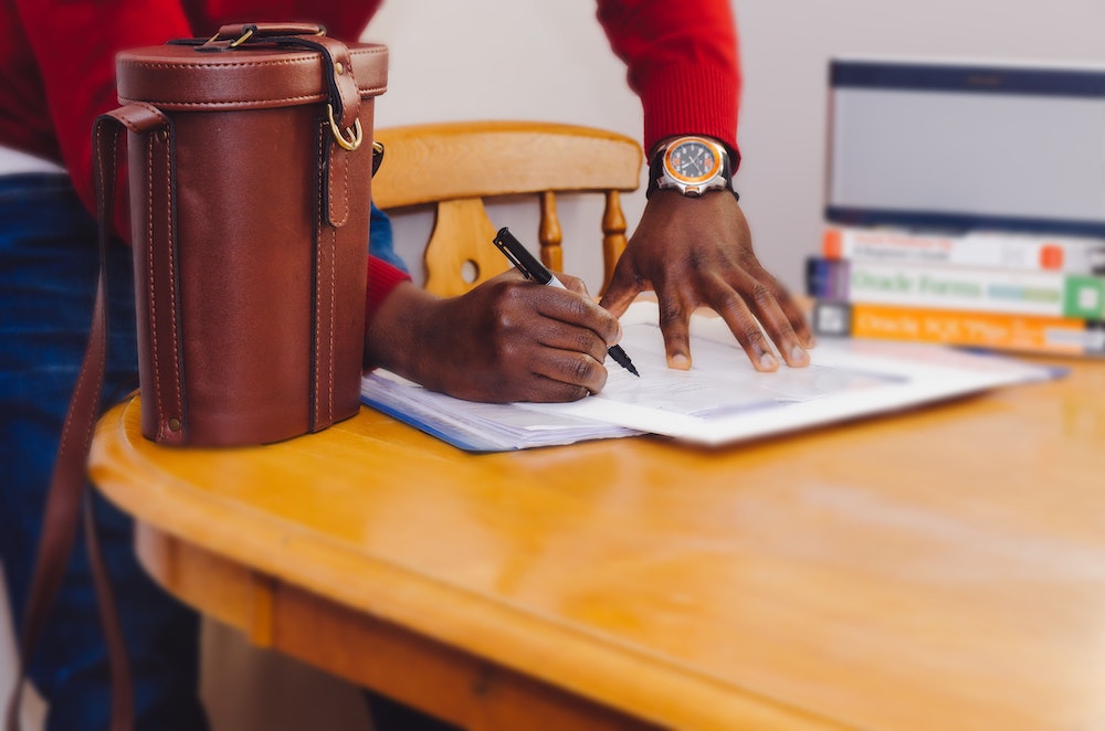 person writing in a notebook