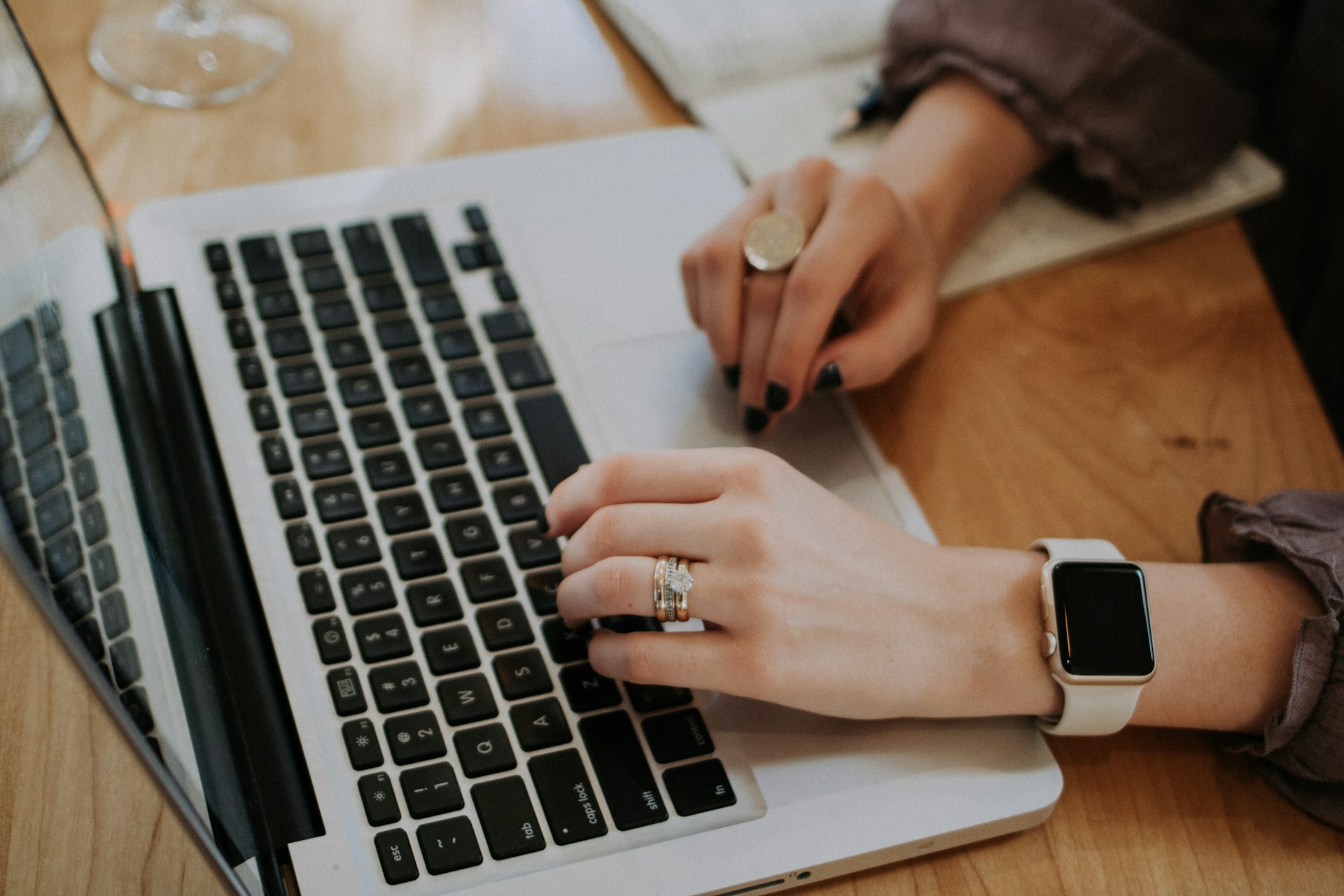 woman typing on a laptop keyboard