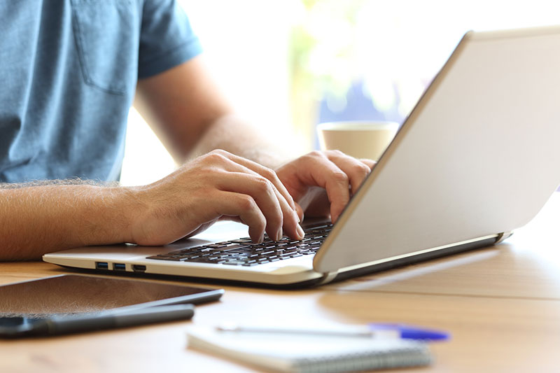 person typing on laptop 